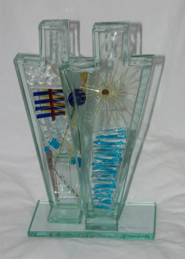 Contemporary bonded glass sculpture featuring two upright geometric forms embedded with coloured rods, gold accents, and layered textures.