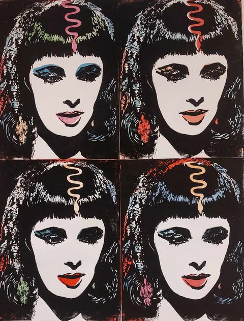 Pop art-inspired linocut featuring four repeated portraits of a woman with blunt fringe, dramatic eyeliner, and a stylised snake motif on her forehead—visually reminiscent of Elizabeth Taylor’s Cleopatra-era glamour. Each portrait varies in colour with bold makeup combinations and shimmering accents, rendered in linocut, spray paint, and gold leaf against a dark background.