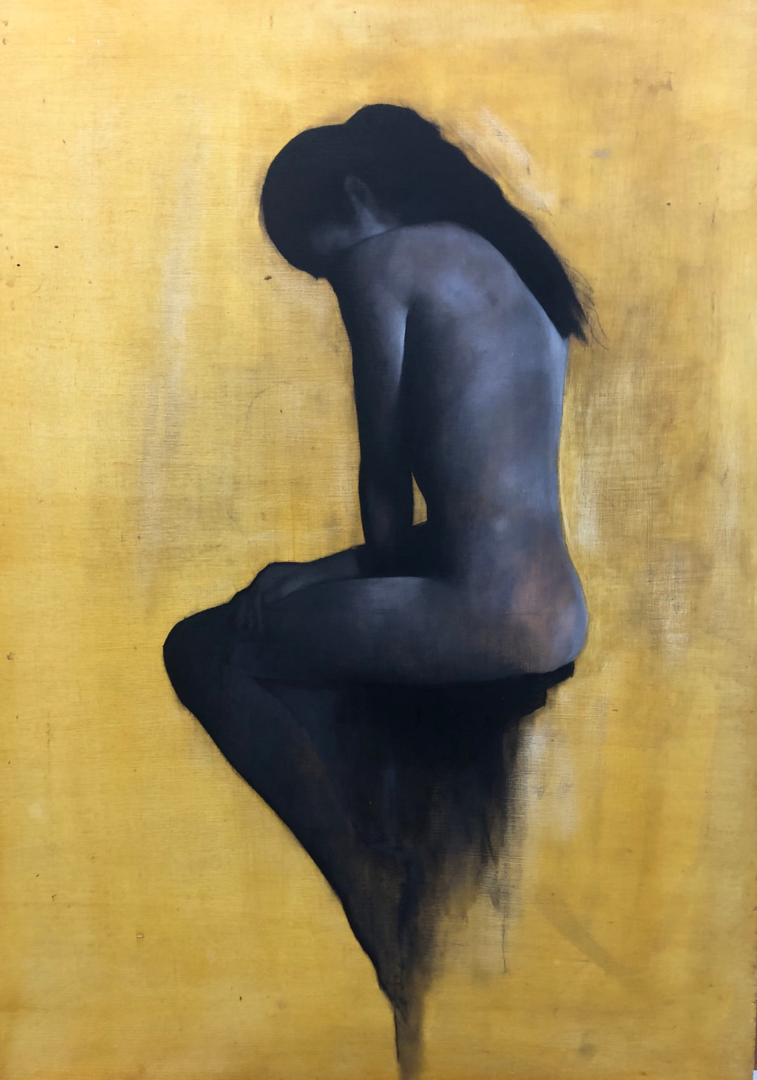 Seated nude female figure painted in dark tones against a warm ochre background.