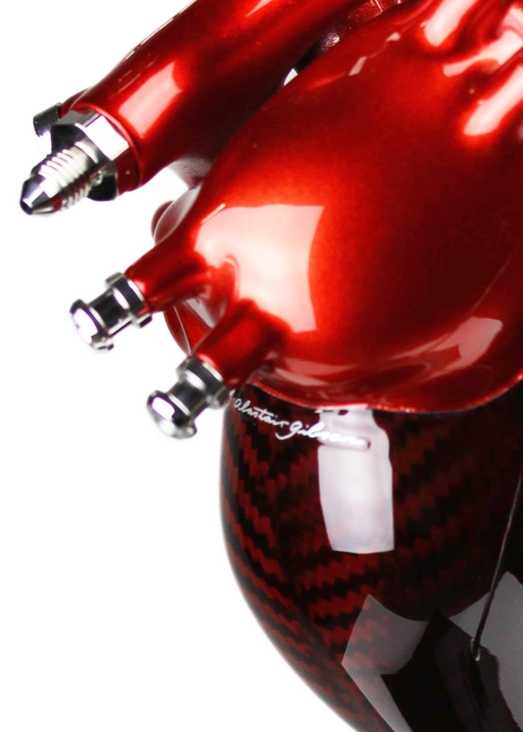 A vivid heart sculpture by Alastair Gibson, crafted from red-tinted 2x2 twill carbon fibre and finished with 3D-printed ABS atriums. Featuring titanium fuel and hydraulic fittings from Grand Prix cars, it fuses organic form with motorsport engineering. Finished in deep racing red with a UV-resistant gloss, it’s desk-mounted on a polished granite base with a stainless steel hydraulic support—blending precision with striking visual impact.