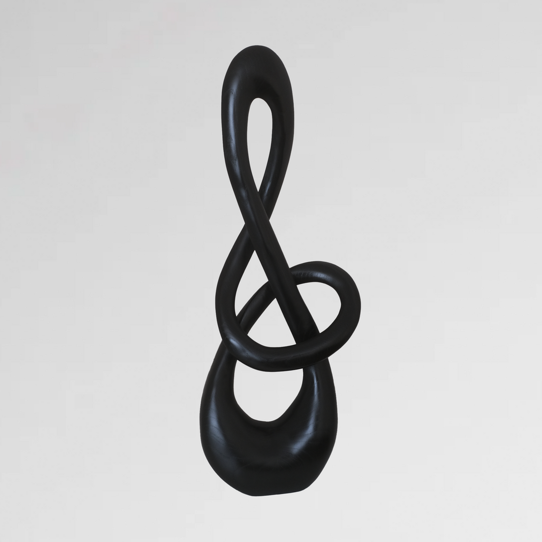 Abstract black sculpture with an elegant looping form resembling a twisted infinity symbol.