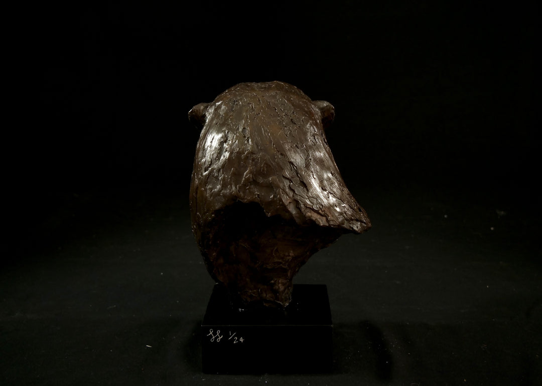 Cold cast stone sculpture of an otter head and neck titled Hindsight by Jamie Lord — finely detailed bust with sleek, sinuous form, warm brown fur tones, dark glassy eyes and alert, turned-back pose. Limited edition of 24 with signed Certificate of Authenticity.