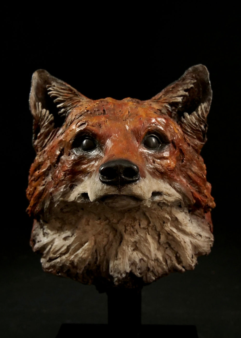 Fox head sculpture on a black background