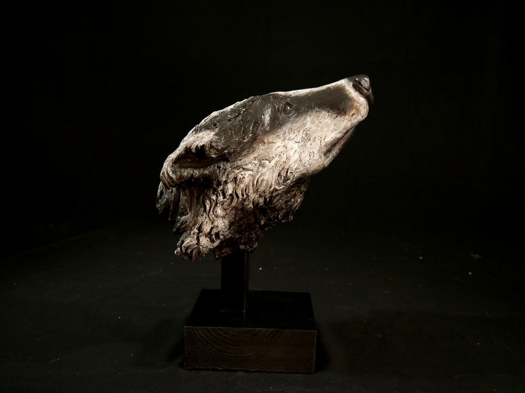 Cold cast slate sculpture of a badger titled Remnant by Jamie Lord — expressive woodland animal bust with textured black-and-grey fur, soft white facial markings, and an upward, reflective gaze. Limited edition of 12 with signed Certificate of Authenticity.
