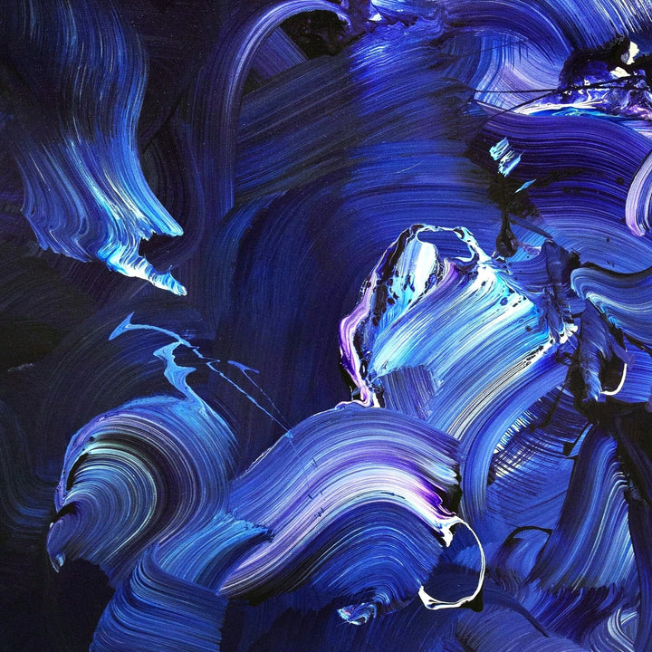 Expressive abstract painting featuring sweeping brushstrokes in deep indigo, cobalt blue, violet, and accents of white. The layered composition creates a sense of fluid motion, depth, and energy on a midnight-toned canvas.