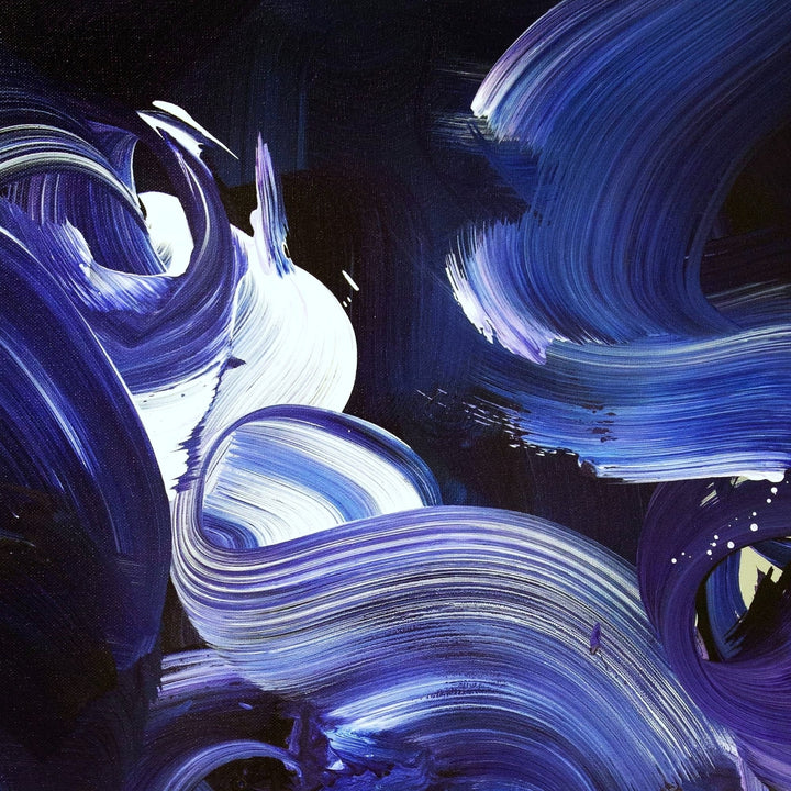 Expressive abstract painting featuring sweeping brushstrokes in deep indigo, cobalt blue, violet, and accents of white. The layered composition creates a sense of fluid motion, depth, and energy on a midnight-toned canvas.