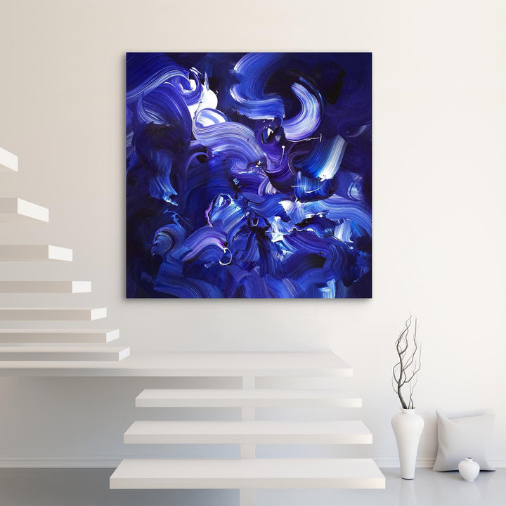 Expressive abstract painting featuring sweeping brushstrokes in deep indigo, cobalt blue, violet, and accents of white. The layered composition creates a sense of fluid motion, depth, and energy on a midnight-toned canvas.