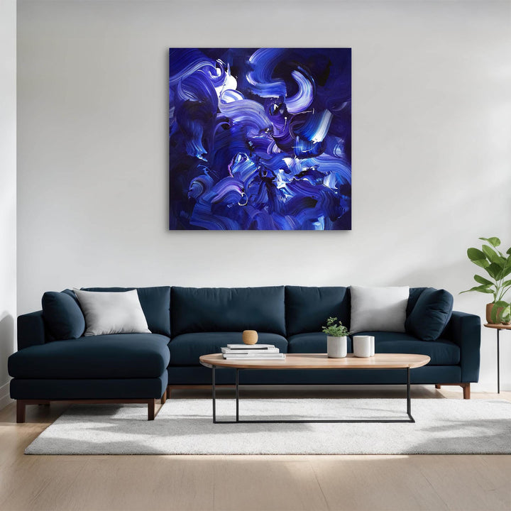 Expressive abstract painting featuring sweeping brushstrokes in deep indigo, cobalt blue, violet, and accents of white. The layered composition creates a sense of fluid motion, depth, and energy on a midnight-toned canvas.