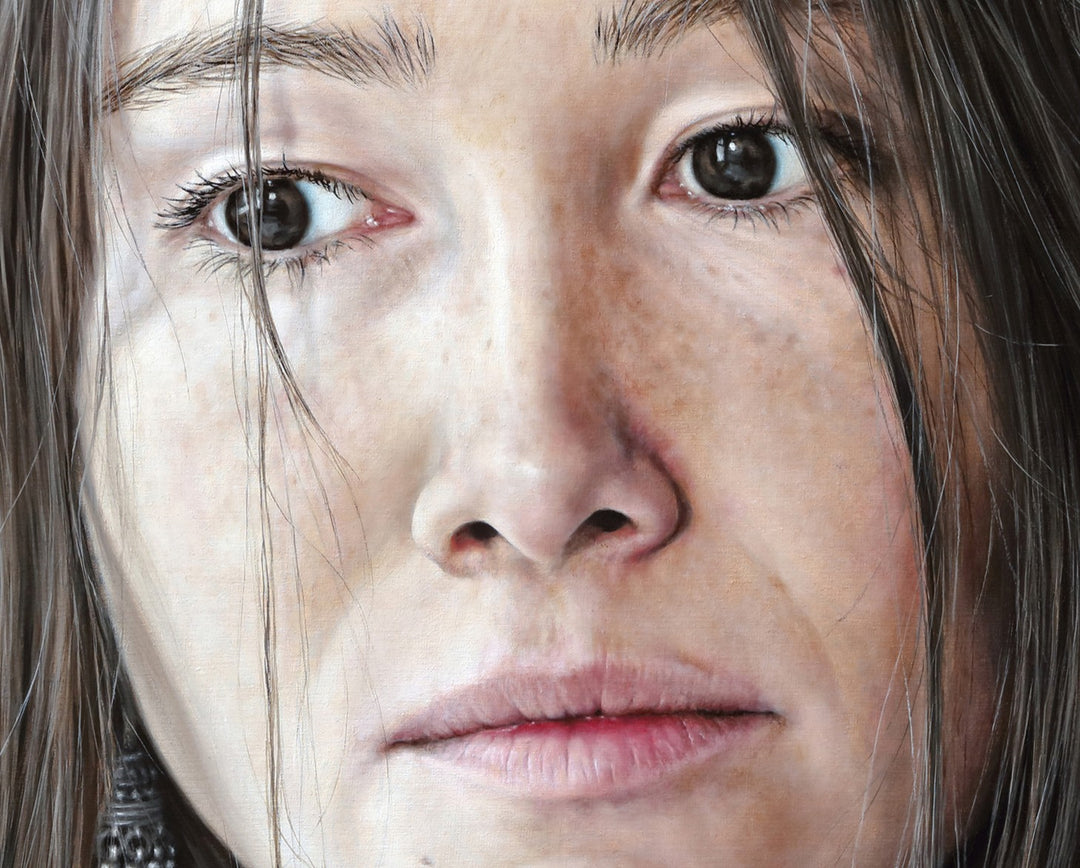Arina Gordienko hyperrealist oil painting Lend Me the Past, a close-up portrait of a young woman with long brown hair falling loosely around her face, her expression marked by sadness and introspection. Set against a deep red background, the work conveys themes of memory, grief, and the longing to rewrite painful moments from the past.