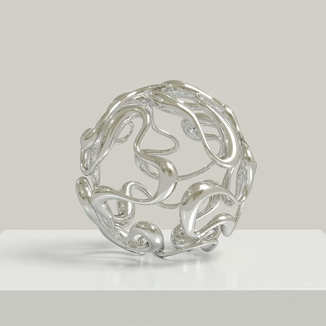Polished cast stainless steel sculpture by Yoni Alter, formed from a continuous, looping line that weaves organically into a perfect sphere. The reflective surface and open structure create a sense of movement, balance, and fluidity from every angle. Self-standing and orientation-free.
