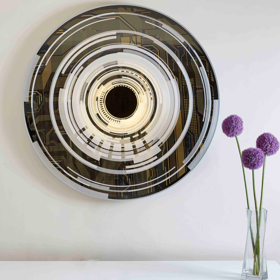 “The Portal” by Ben Rousseau – a circular illuminated artwork blending acrylic, LED, and brass. Featuring concentric rings and circuit-inspired patterns in gold, white, and black, it transforms technology into art and light into architectural sculpture.


