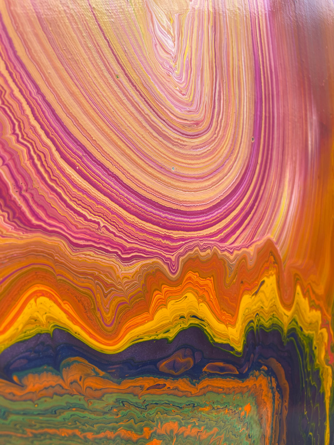 Large vibrant abstract painting “Sun Chaser” by Swarez — a powerful composition of swirling, layered colour featuring vivid yellow bursts cutting across deep oranges, fiery reds, rich magentas, lush greens, electric blues, dark purples and intense black accents. Complex ribbons and rivers of enamel paint create fluid movement and luminous depth on a grand-scale canvas.
