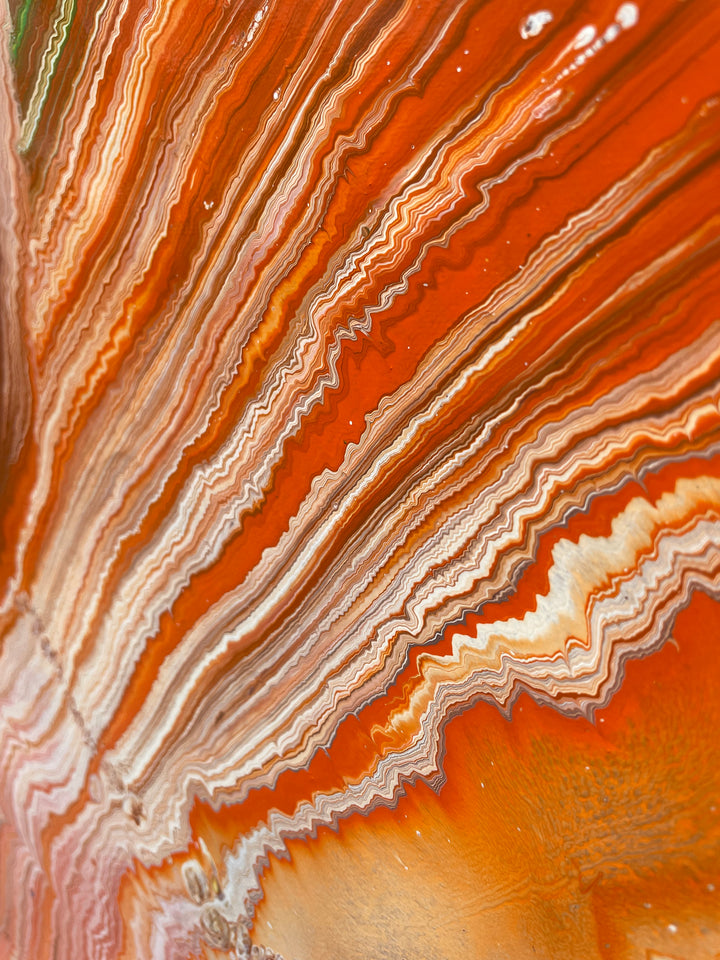 Large vibrant abstract painting “Sun Chaser” by Swarez — a powerful composition of swirling, layered colour featuring vivid yellow bursts cutting across deep oranges, fiery reds, rich magentas, lush greens, electric blues, dark purples and intense black accents. Complex ribbons and rivers of enamel paint create fluid movement and luminous depth on a grand-scale canvas.