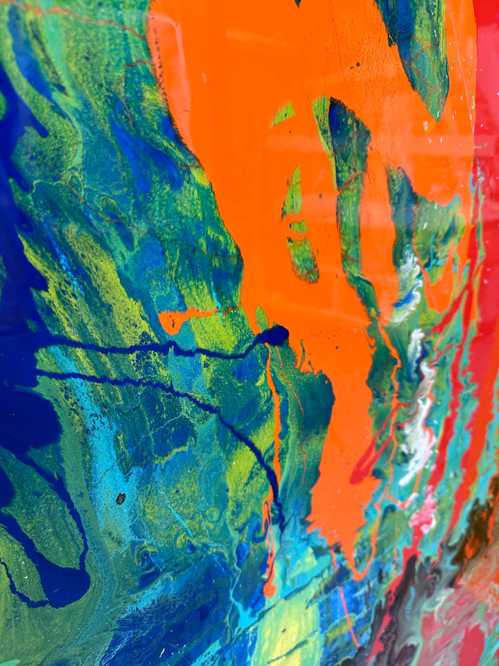 Large abstract painting “Infinite Light” by Swarez — vibrant sweeping strokes of scarlet red, fiery orange and deep burgundy layered over a luminous turquoise and lime green base, with accents of cobalt blue and black. Highly textured enamel surface with bold movement and glossy, light-catching details.