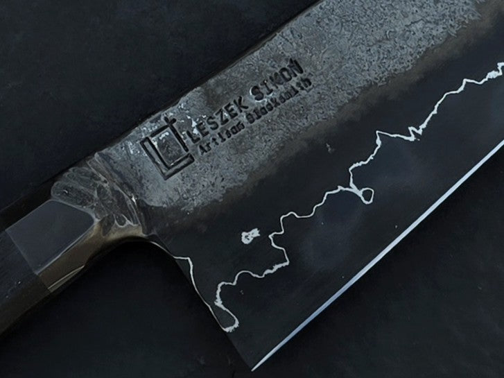 Leszek Sikon San Mai Graphite Petty hand-forged kitchen knife with laminated carbon steel blade, visible hamon line and bog oak handle.