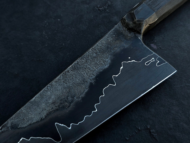 Leszek Sikon San Mai Graphite Petty hand-forged kitchen knife with laminated carbon steel blade, visible hamon line and bog oak handle.