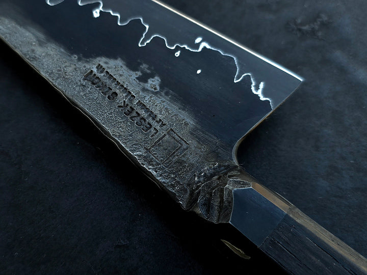 Leszek Sikon San Mai Graphite Petty hand-forged kitchen knife with laminated carbon steel blade, visible hamon line and bog oak handle.