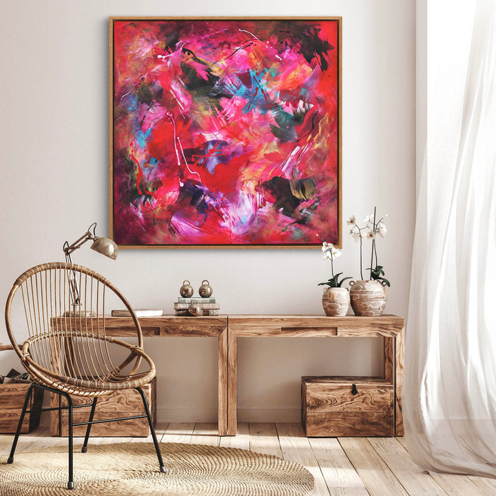 Energetic abstract painting dominated by vivid red, pink, and magenta tones with expressive brushstrokes, splashes of turquoise, black, and white on a dynamic, layered background.