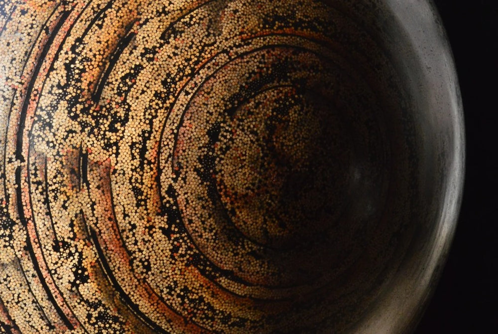 Textured hemispherical sculpture by Richard Slee titled “Nebula Core.” Made from hundreds of upright bamboo skewers embedded in black resin, the surface is meticulously hand coloured with pencil in swirling, planetary patterns. The final effect resembles a cosmic vortex or galactic core, rendered in warm earthy tones with rich texture and depth.