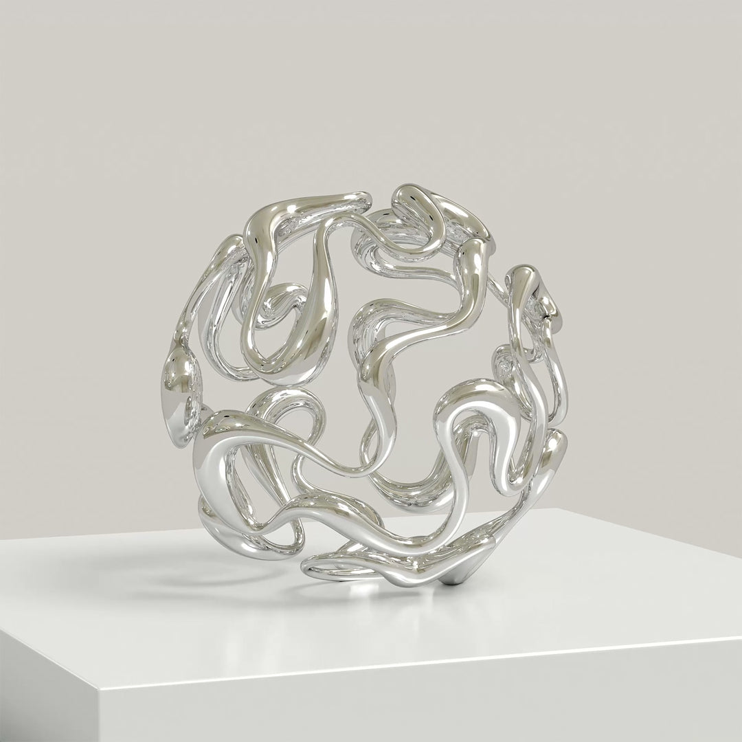Polished cast stainless steel sculpture by Yoni Alter, formed from a continuous, looping line that weaves organically into a perfect sphere. The reflective surface and open structure create a sense of movement, balance, and fluidity from every angle. Self-standing and orientation-free.