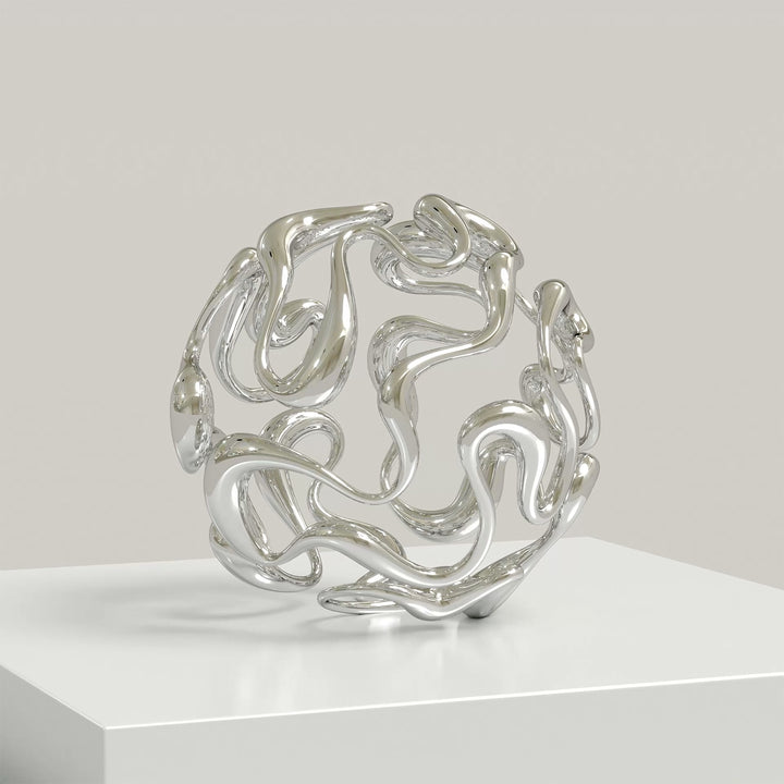 Polished cast stainless steel sculpture by Yoni Alter, formed from a continuous, looping line that weaves organically into a perfect sphere. The reflective surface and open structure create a sense of movement, balance, and fluidity from every angle. Self-standing and orientation-free.