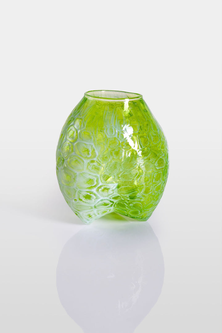 Blown green glass vessel with embossed floral-like texture and a softly bulbous form, featuring a subtly dimpled base and translucent finish.