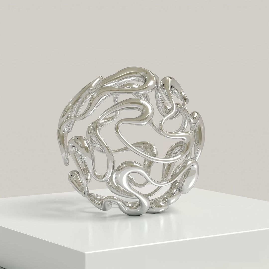 Polished cast stainless steel sculpture by Yoni Alter, formed from a continuous, looping line that weaves organically into a perfect sphere. The reflective surface and open structure create a sense of movement, balance, and fluidity from every angle. Self-standing and orientation-free.