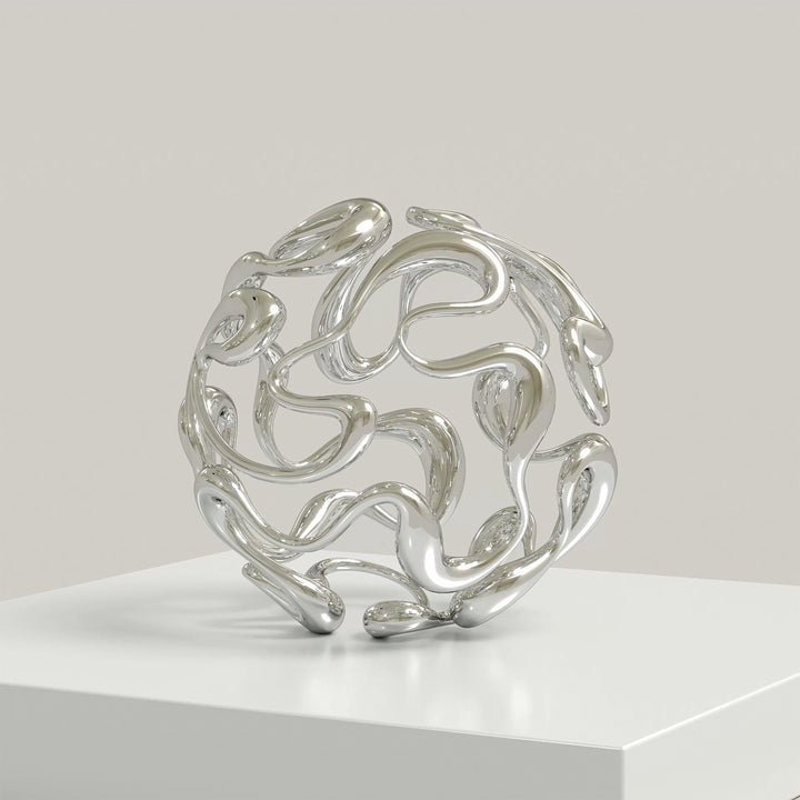 Polished cast stainless steel sculpture by Yoni Alter, formed from a continuous, looping line that weaves organically into a perfect sphere. The reflective surface and open structure create a sense of movement, balance, and fluidity from every angle. Self-standing and orientation-free.