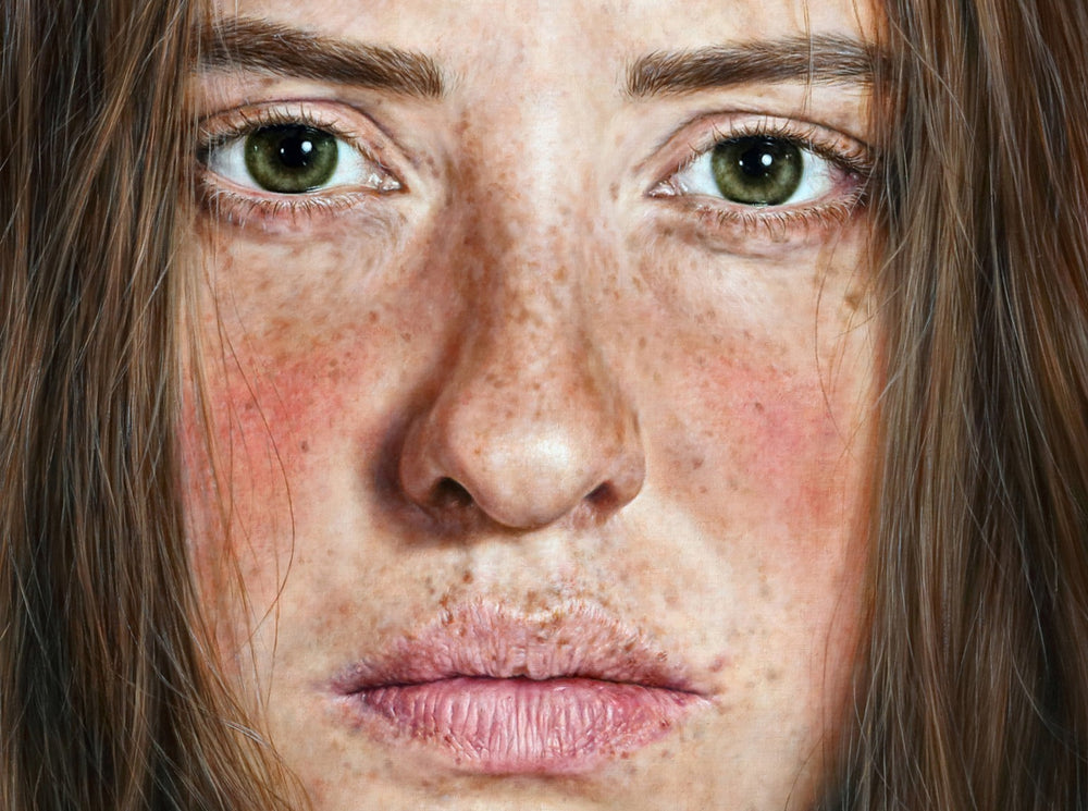 Arina Gordienko hyperrealist oil painting Life in Crimson Flame, depicting a young woman with freckled skin, green eyes, and long brown hair, wearing a vivid red blouse and layered red bead necklace against a deep red background. The portrait conveys resilience, emotional depth, and the struggle between past sorrow and future hope.