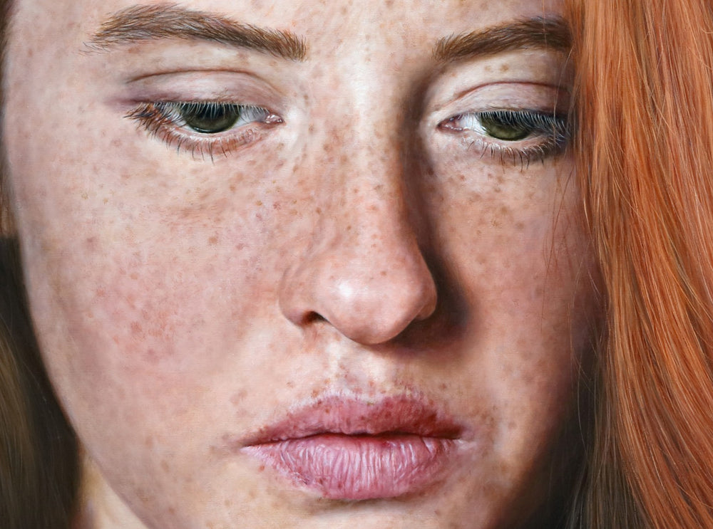 Arina Gordienko hyperrealist oil painting Long Walk Alone in the Tender Flame, portraying a young woman with auburn hair and freckled skin, shown in close-up against a vivid crimson red background. Her downward gaze conveys melancholy, resilience, and quiet strength, reflecting themes of struggle, hope, and endurance through hardship.