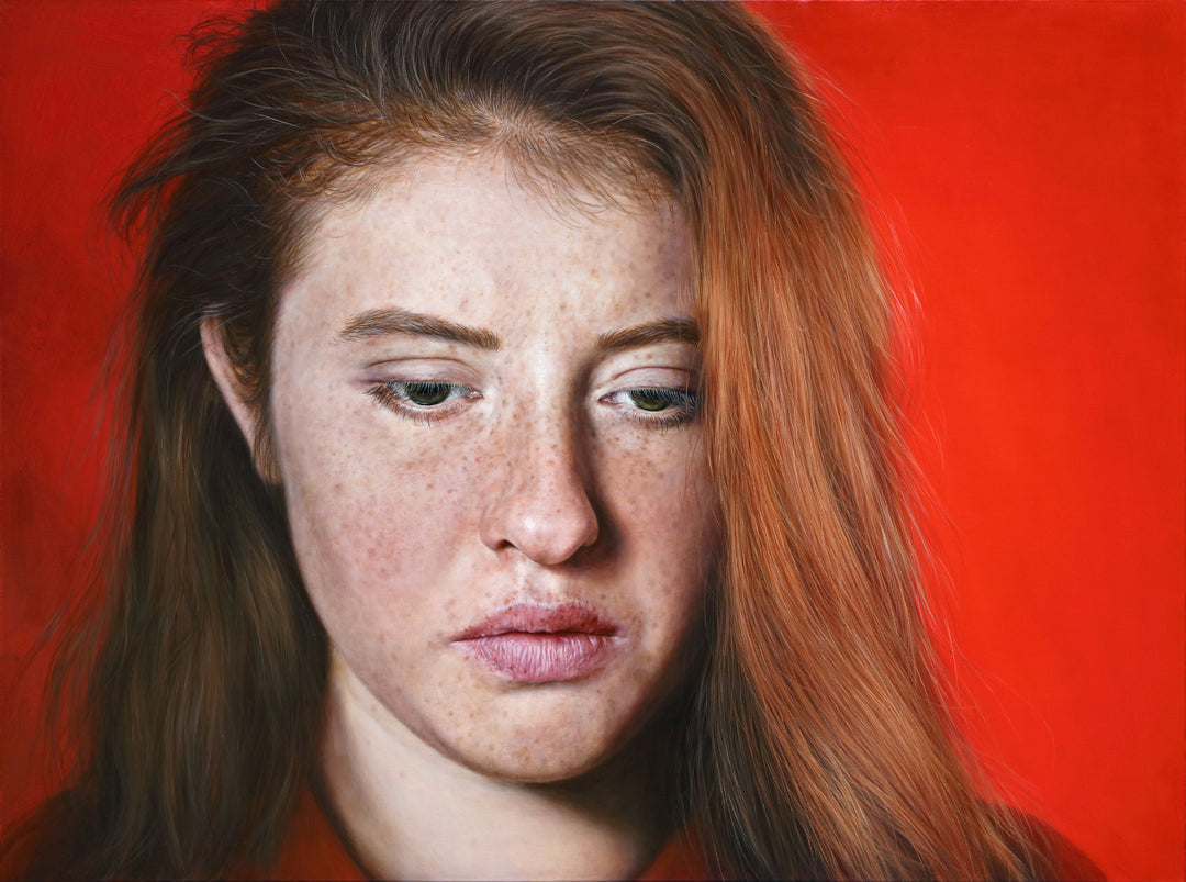 Arina Gordienko hyperrealist oil painting Long Walk Alone in the Tender Flame, portraying a young woman with auburn hair and freckled skin, shown in close-up against a vivid crimson red background. Her downward gaze conveys melancholy, resilience, and quiet strength, reflecting themes of struggle, hope, and endurance through hardship.