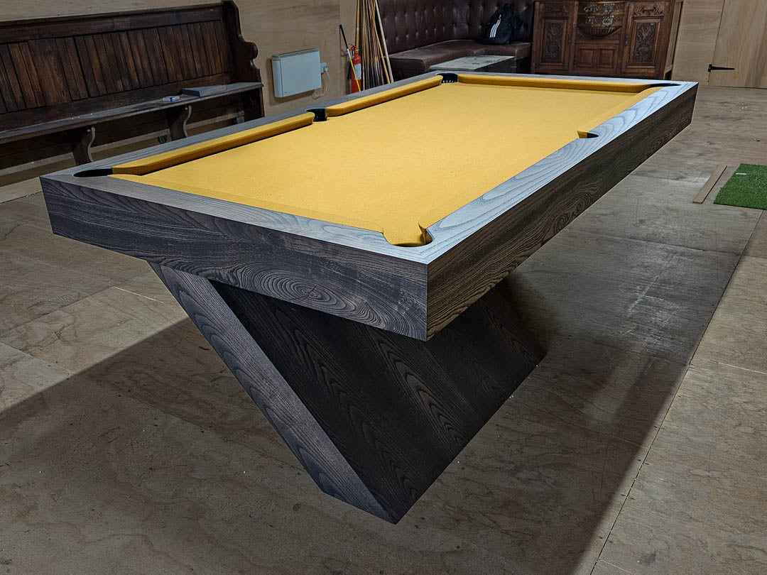 Sir William Bentley Billiards Cantilever 7ft pool table in grey ash with sculptural angled base and tan cloth, showcasing a bold architectural design.
