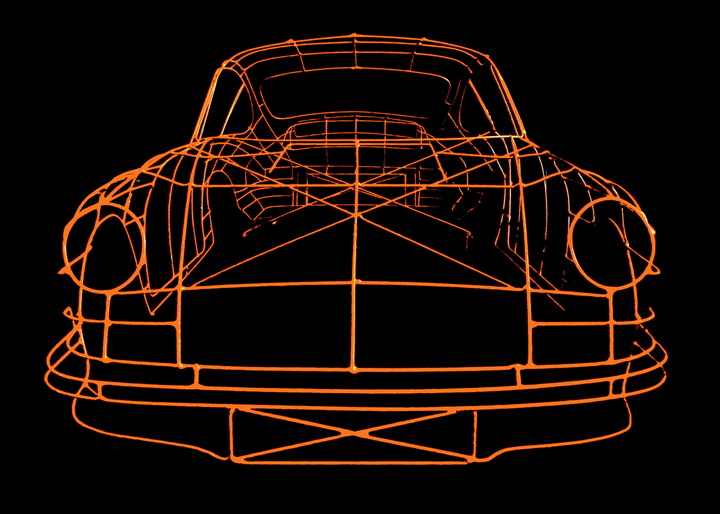 Handcrafted Porsche 911 2.7 RS wire sculpture by Chris Twitchell, finished in vivid Tangerine orange with black Carrera script. This detailed artwork captures the iconic pre-impact bumper 911 form — from its classic round headlights to the signature ducktail spoiler — reimagined as a precision-engineered wireframe sculpture that celebrates Porsche’s timeless design and performance heritage.