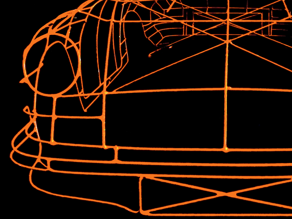 Handcrafted Porsche 911 2.7 RS wire sculpture by Chris Twitchell, finished in vivid Tangerine orange with black Carrera script. This detailed artwork captures the iconic pre-impact bumper 911 form — from its classic round headlights to the signature ducktail spoiler — reimagined as a precision-engineered wireframe sculpture that celebrates Porsche’s timeless design and performance heritage.