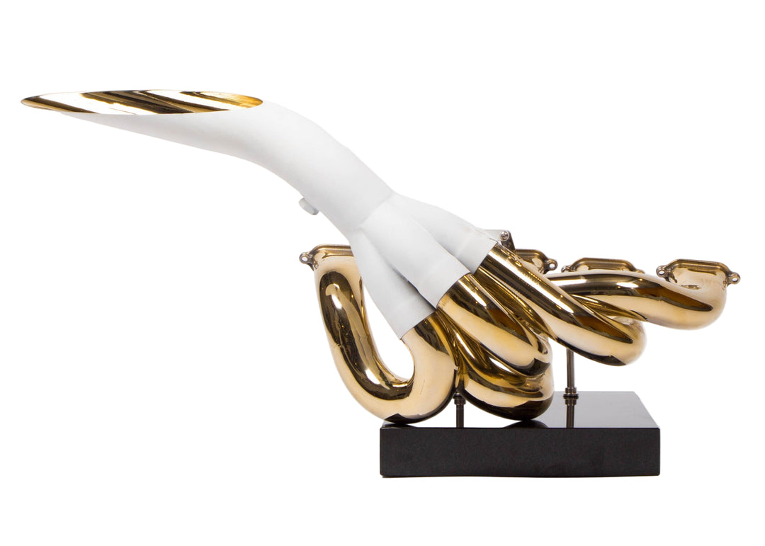 One-of-one sculptural artwork by Mike O’Connor created from the complete race-used exhaust system of the 2001 Jordan EJ11 Formula One car. The piece is fully plated in 24-karat gold, showcasing hand-polished Inconel pipes mounted on a sleek black plinth. This gleaming sculpture celebrates the V10 era of Formula One and the engineering innovation of Eddie Jordan’s team