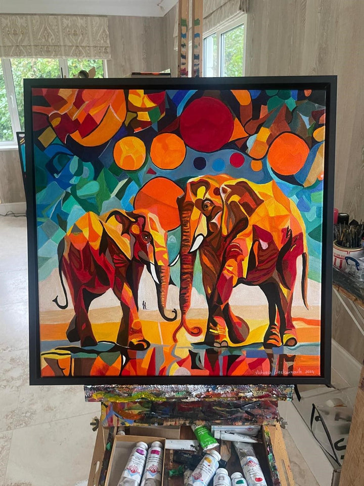 Two abstract elephants in bold, vivid colours with geometric backgrounds and circular sun motifs.

