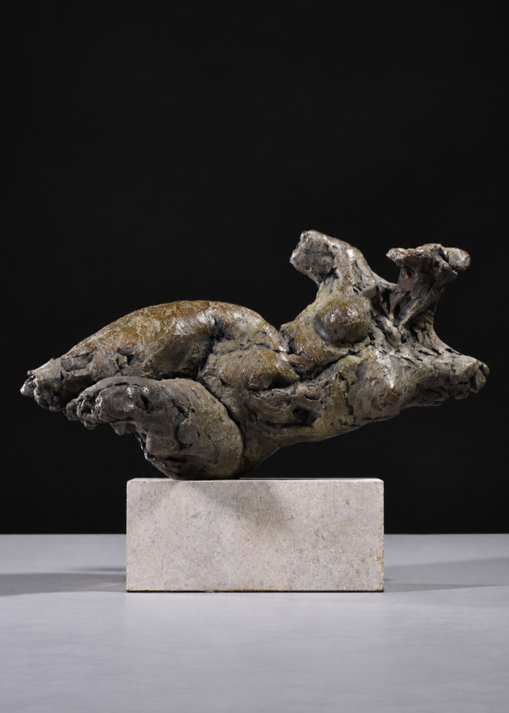 ‘Nude Emergence Torso’ by Hamish Mackie, a limited-edition contemporary bronze figurative sculpture depicting a fragmented reclining female nude torso. Inspired by ancient sculptural artefacts, the abstracted human form features rough, expressive modelling, weathered surfaces and an earthy brown bronze patina. Mounted horizontally on a rectangular Ancaster Weatherbed stone plinth, the sculpture explores the natural beauty and tactile qualities of the female form.