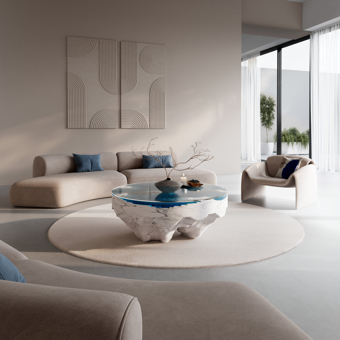 Duffy London Abyss Marble Horizon coffee table in white Carrara marble with layered blue glass, creating a sculptural ocean-depth illusion within a circular form.
