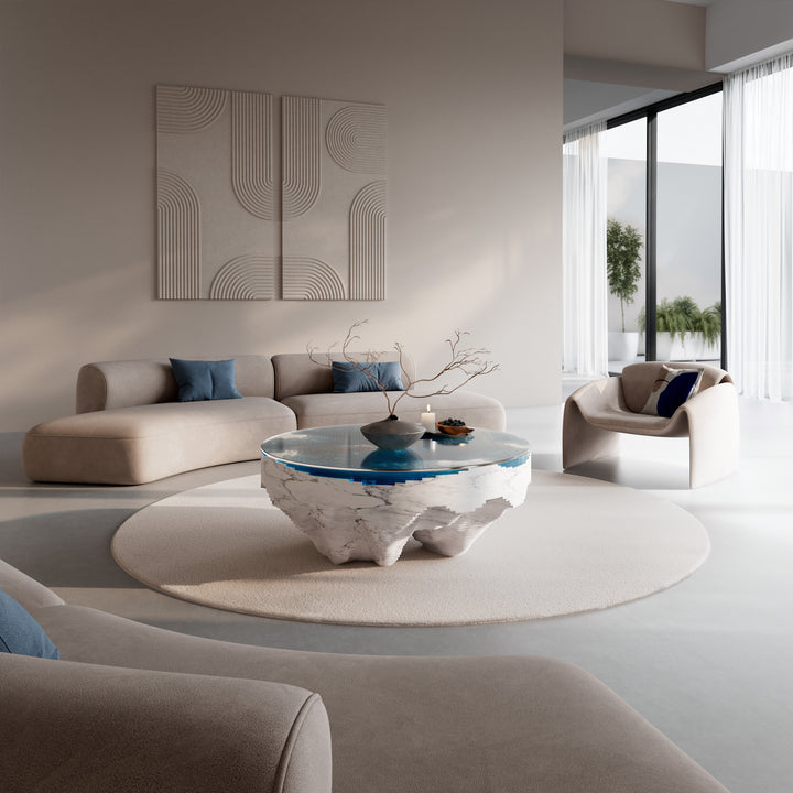 Duffy London Abyss Marble Horizon coffee table in white Carrara marble with layered blue glass, creating a sculptural ocean-depth illusion within a circular form.