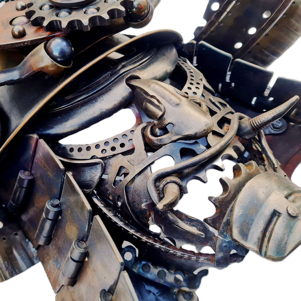 Samurai-inspired helmet sculpture crafted from reclaimed metal with intricate steampunk detailing.
