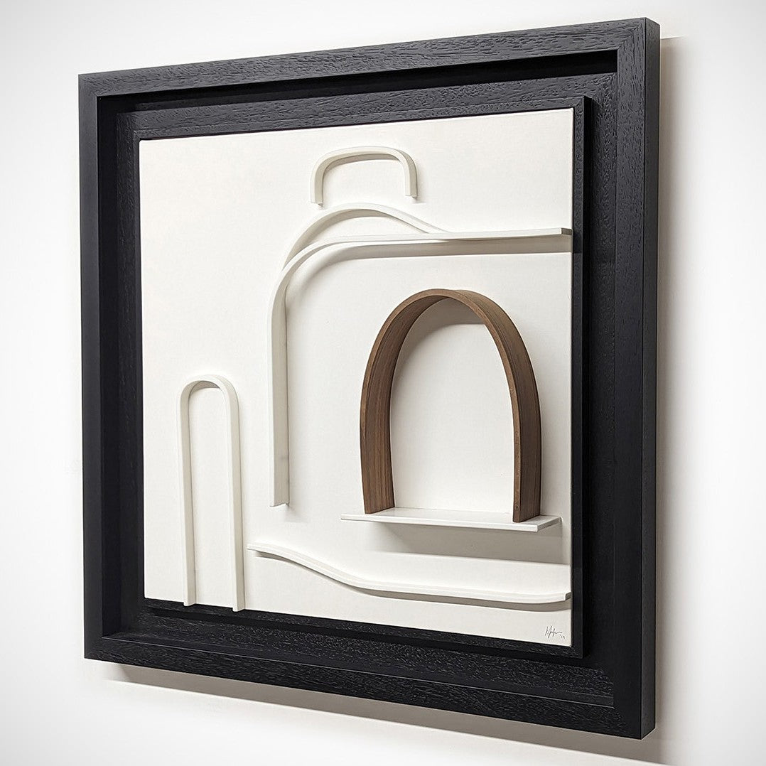 Minimalist wall sculpture of the 1930s Bugatti Type 35B Grand Prix car by Jonny Ambrose — crisp white Corian relief with warm walnut arch detail, framed in deep black for bold gallery impact.