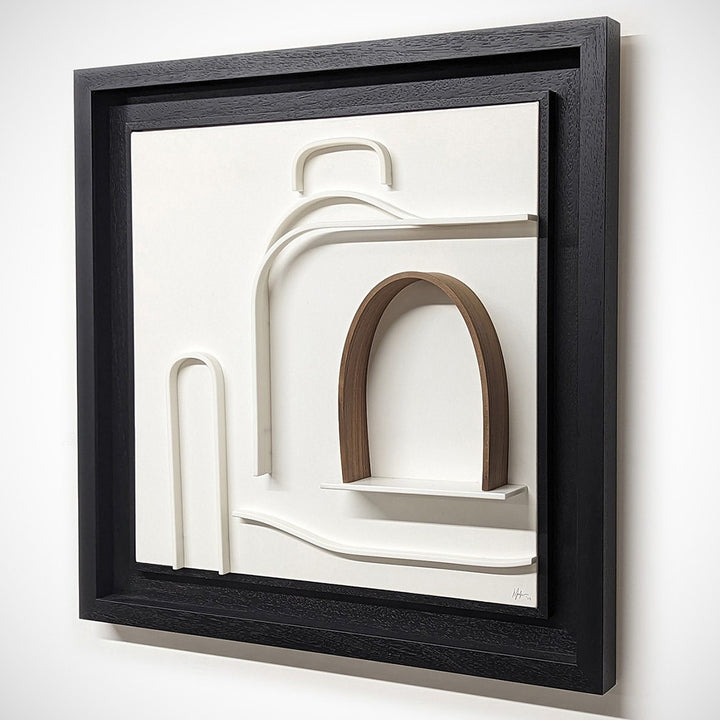 Minimalist wall sculpture of the 1930s Bugatti Type 35B Grand Prix car by Jonny Ambrose — crisp white Corian relief with warm walnut arch detail, framed in deep black for bold gallery impact.
