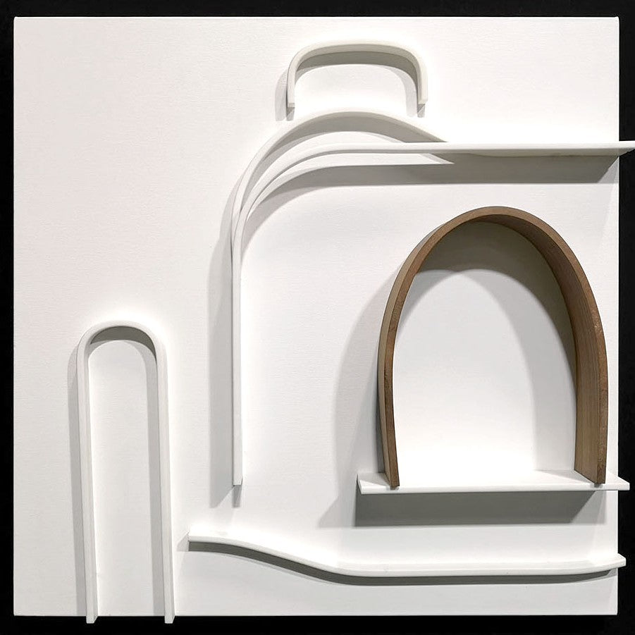 Minimalist wall sculpture of the 1930s Bugatti Type 35B Grand Prix car by Jonny Ambrose — crisp white Corian relief with warm walnut arch detail, framed in deep black for bold gallery impact.