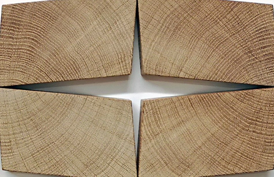 Abstract oak wall sculpture by Jonny Ambrose — twelve angled endgrain oak blocks arranged to shift and expand across a clean white canvas, creating depth, movement, and warm natural texture.