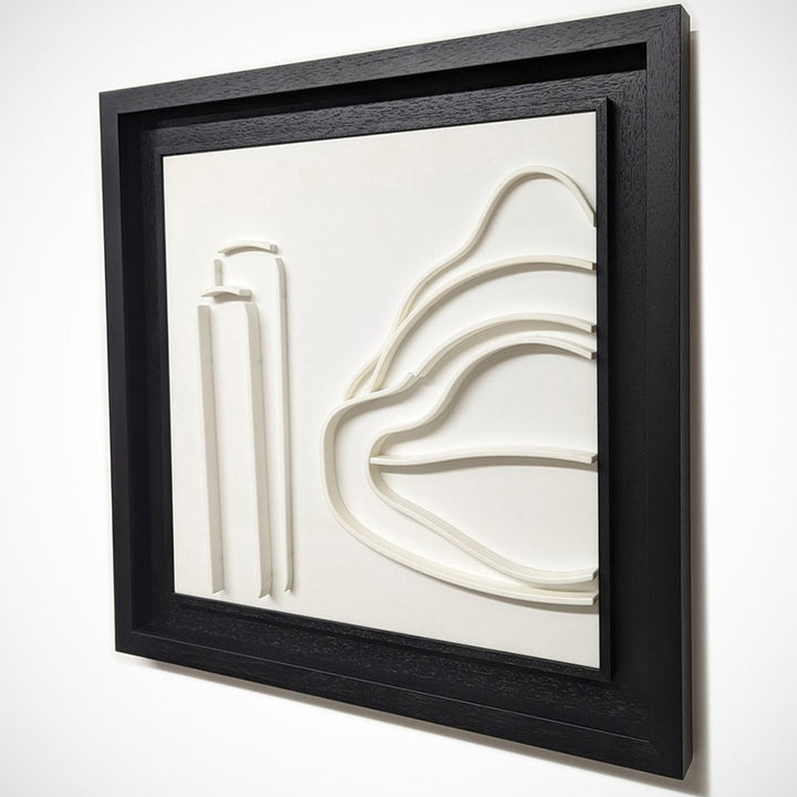 Minimalist white wall sculpture of a 1930s Mercedes W154 Grand Prix car by Jonny Ambrose — abstract flowing lines in thermoformed Corian creating an elegant automotive relief with deep black frame.