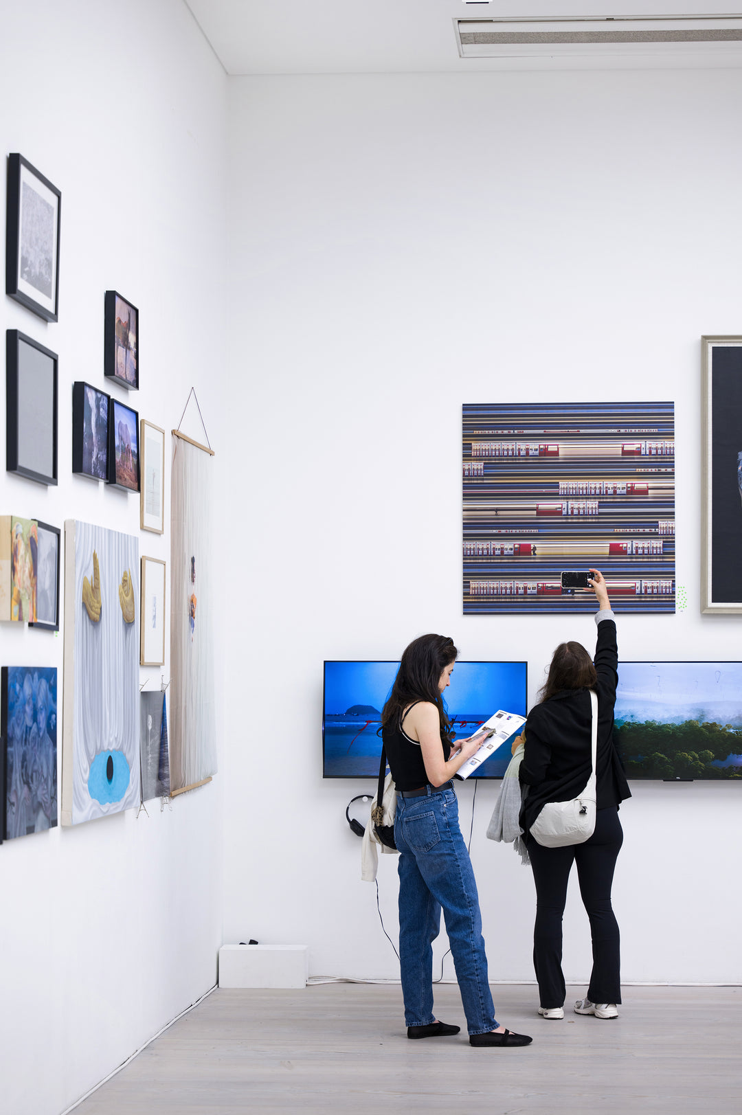 Richard P Jones District Line #2, London fine art photographic print showing layered London Underground District Line trains and commuters moving through a station platform, created from reconstructed high-speed video imagery and printed as a giclée on brushed aluminium.