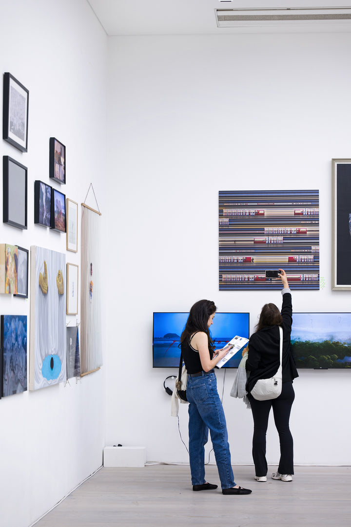 Richard P Jones District Line #2, London fine art photographic print showing layered London Underground District Line trains and commuters moving through a station platform, created from reconstructed high-speed video imagery and printed as a giclée on brushed aluminium.