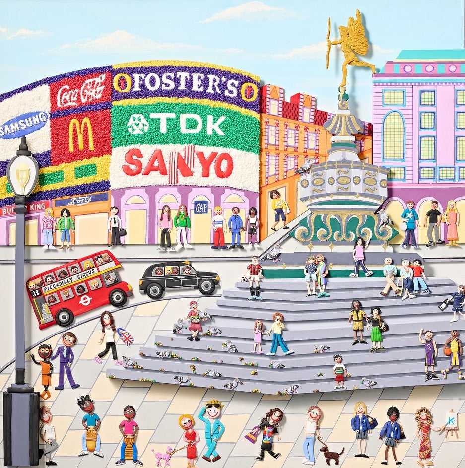 A vibrant, three-dimensional polymer clay artwork of Piccadilly Circus, featuring the iconic curved billboard with brands like Coca-Cola, McDonald’s, and TDK rendered in colourful textured beads. The street scene below includes a classic red double-decker bus marked “38 Piccadilly Circus,” a London black cab, and crowds of joyful figures in bright handmade outfits. Sculpted pigeons dot the grey stone steps beneath the Shaftesbury Memorial Fountain with a golden winged Eros above. 