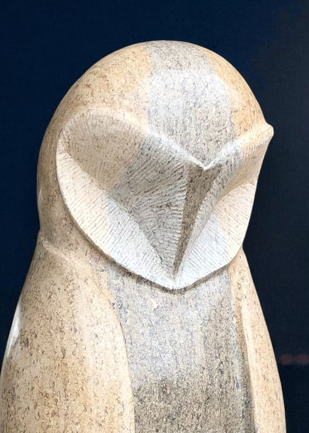Hand-carved stone barn owl sculpture in Ancaster Weatherbed limestone, tall and elegant on a plinth with a smooth stylised form.