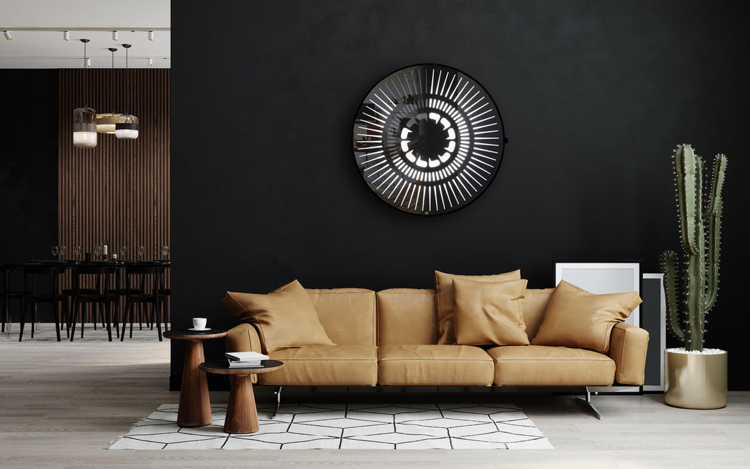 “Tempus Obsidian” by Ben Rousseau – a limited-edition illuminated wall timepiece crafted from grey mirrored glass and brass-tinted aluminium with LEDs. Inspired by obsidian, it radiates calm through subtle light and refined design.

